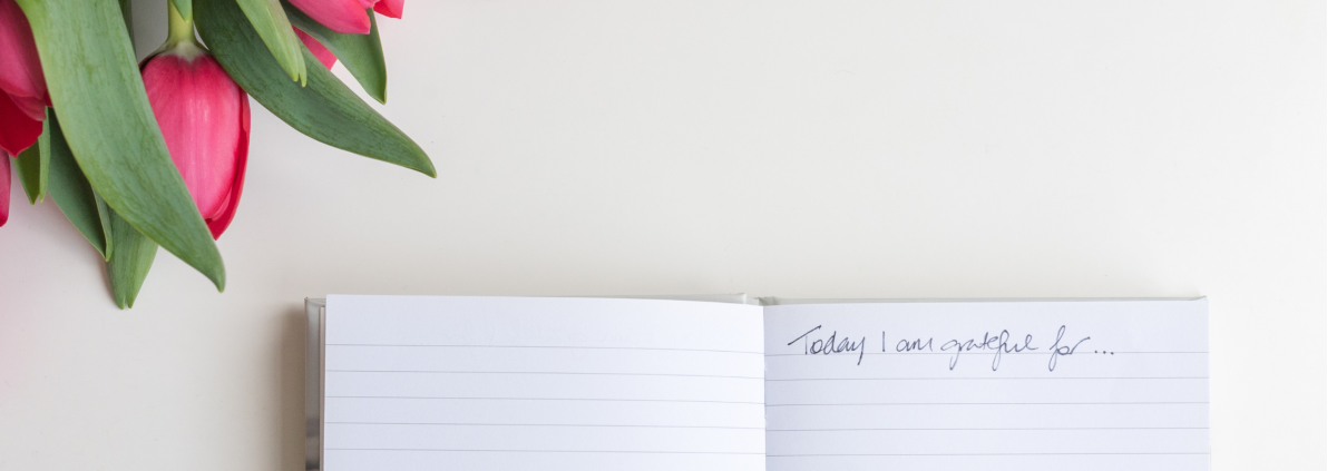 open book with a pen on a desk